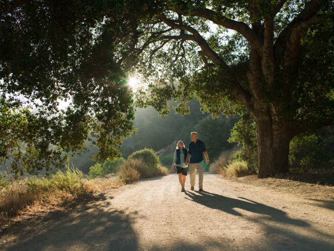 mature couple waking down dirt road