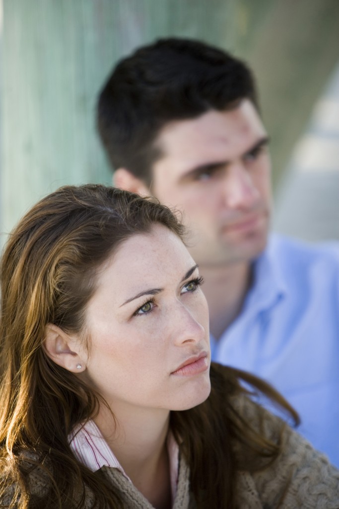 A woman and man gaze off in contemplation