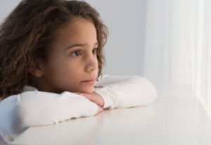 Young Girl Staring out Window