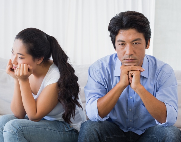 Couple not talking after a dispute on the sofa