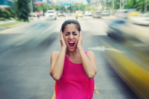 Portrait business woman screaming at street car traffic