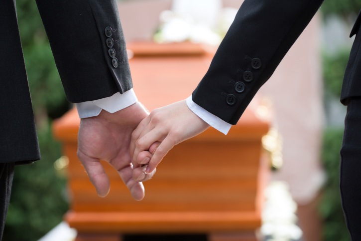 People at funeral consoling each other