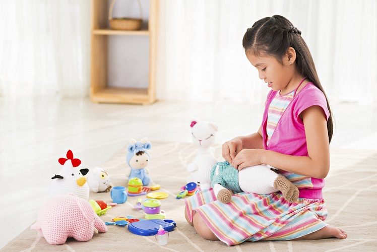 young girl playing with toys