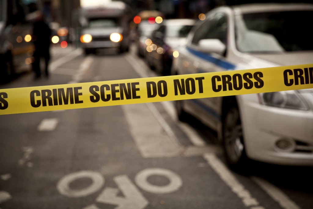 Crime scene tape and emergency vehicles