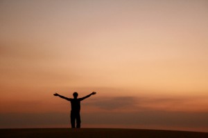 Silhouette of a man on a dune at sunset 