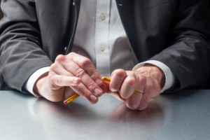 businessman breaking a pencil out of nervousness at the office