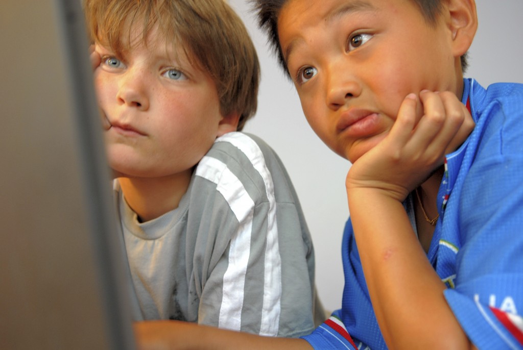 Two boys looking at a computer