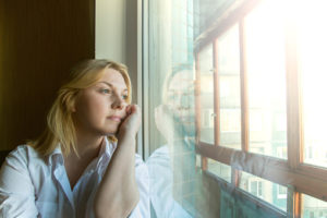 Woman looking out window