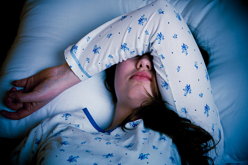 woman with flu lying in bed