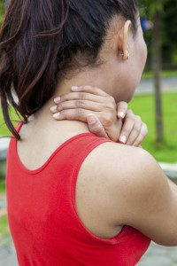 Asian Woman having pain in her neck while exercise