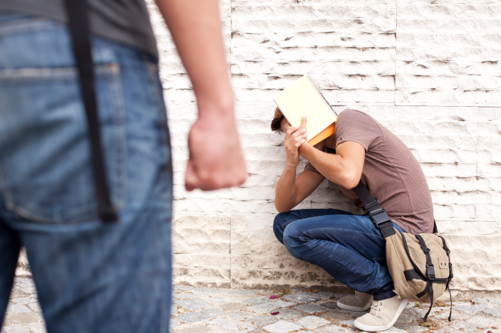 Boy getting bullied in alleyway by other boy