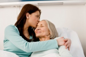 daughter kissing aging mother