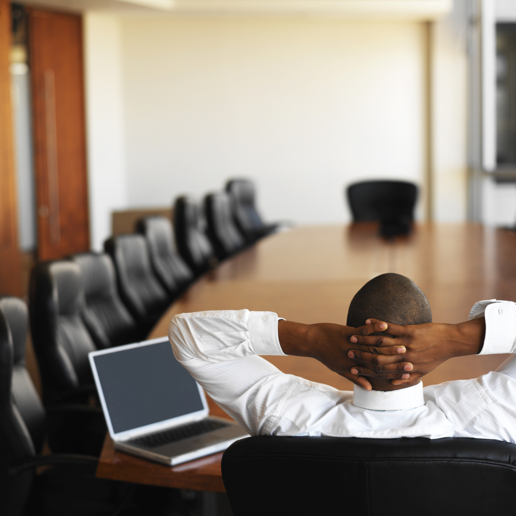 Businessman relaxing at table in conference room