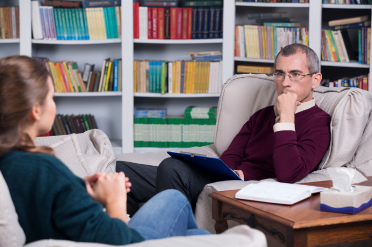 Woman in therapy session with male therapist