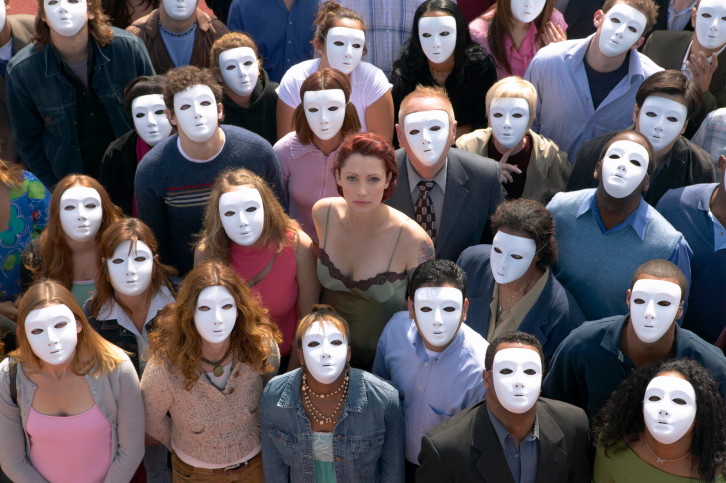 Woman Surrounded by a Crowd of People Wearing Masks