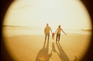 Father and mother with their daughter at the beach