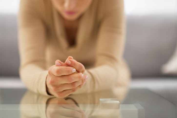 Closeup of hands belonging to worried woman