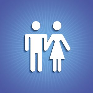 White male and female silhouette holding hands on blue background