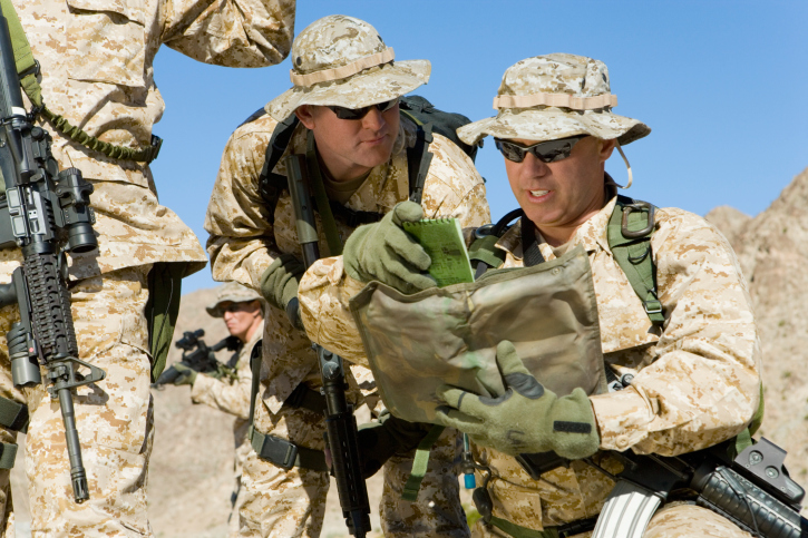 Two Marines look at a map