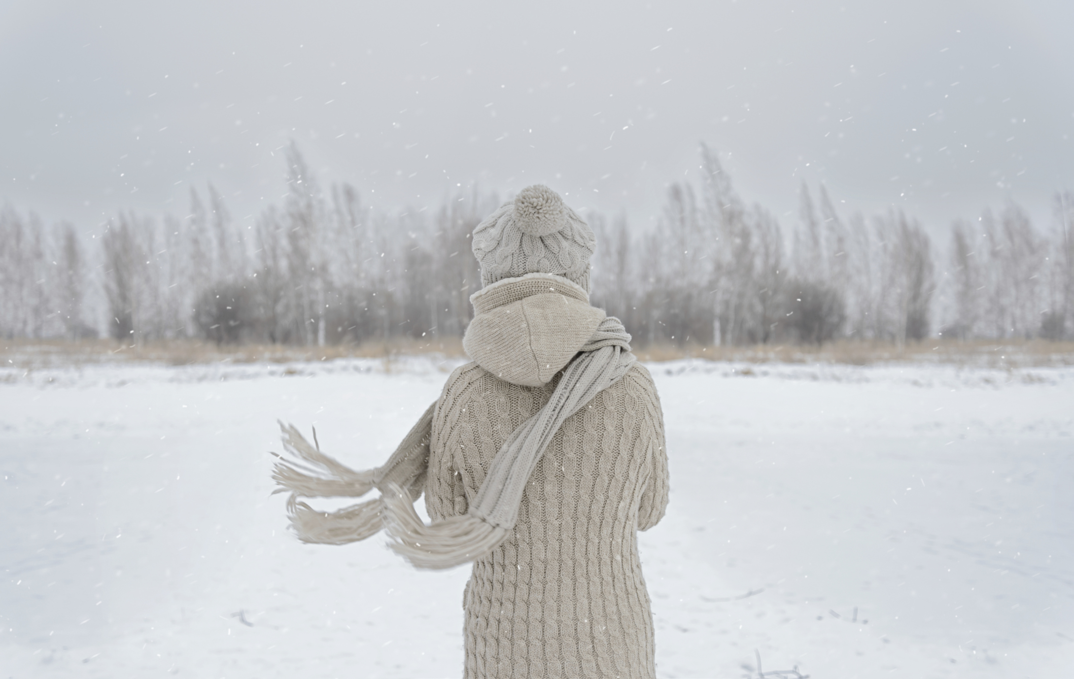 Person standing in the middle of a snowy meadow