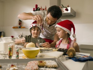 Father baking cookies with children