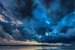 Storm clouds gathering over water