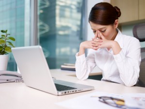 Woman lost in thought at desk