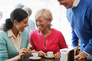 Woman laughing with parents at restaurant