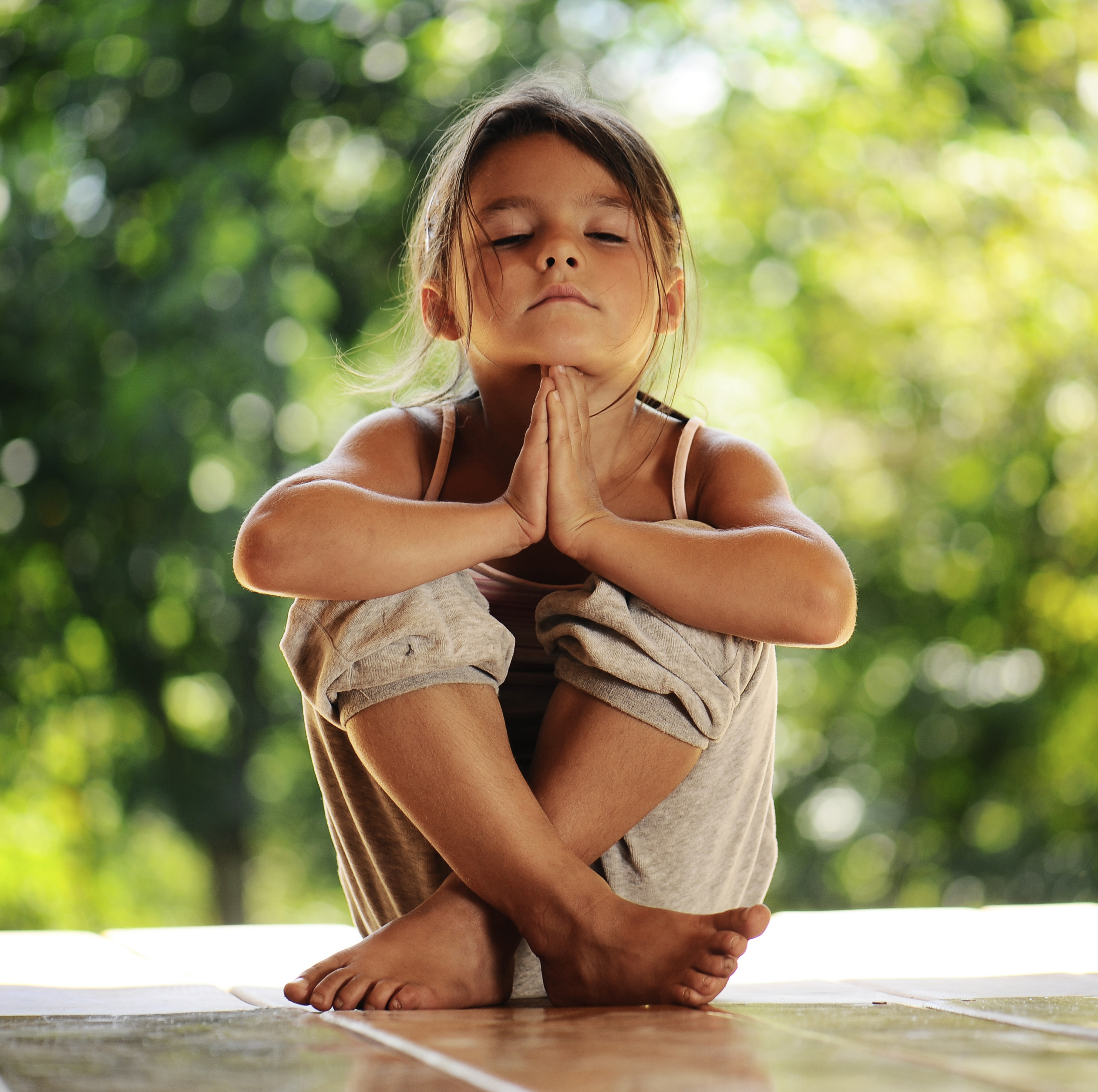 Little girl meditating outside