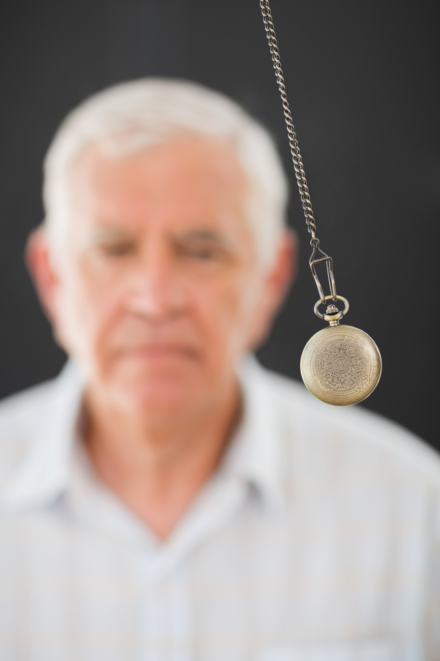 Man being hypnotized with a pendulum