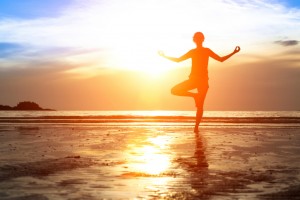 Practicing yoga on the beach