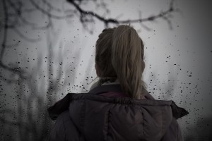 Woman standing outside in the rain