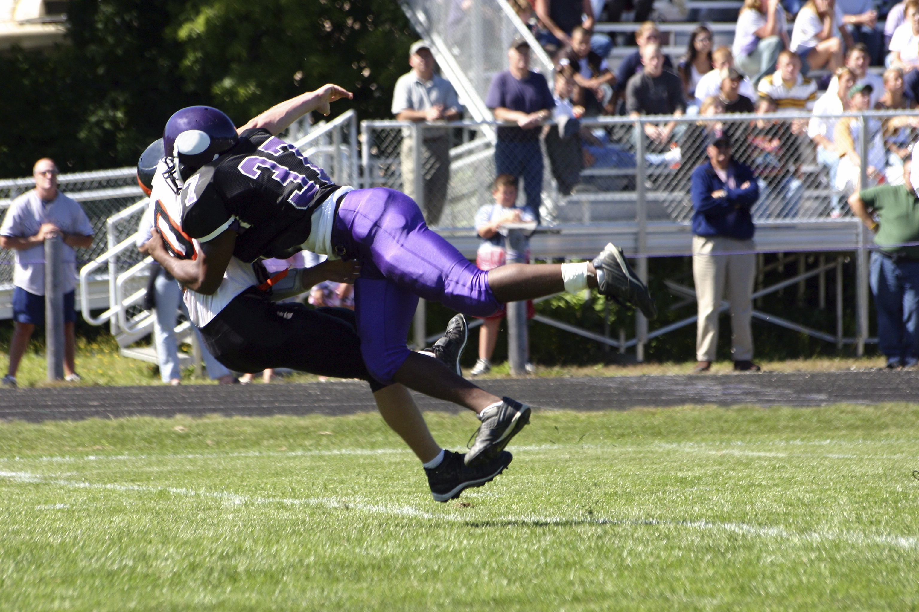 Football players locked in tackle