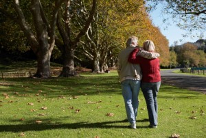 Mature couple walking in park, rear view