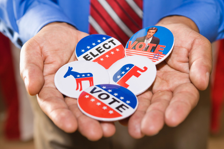 Holding political campaign buttons