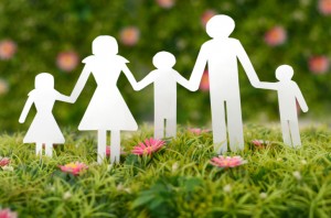 Paper cutout of family on background of grass