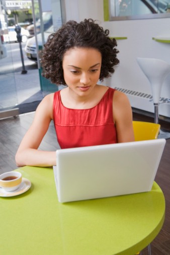Woman using laptop at cafe