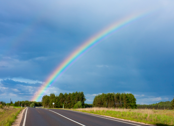 Rainbow over a road landscape