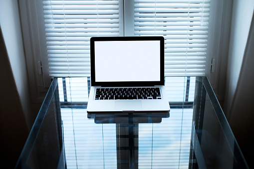 Laptop computer on glass table