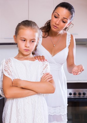 Mother talking to daughter about behavior
