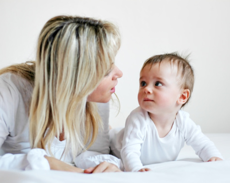 Mother talking to young baby