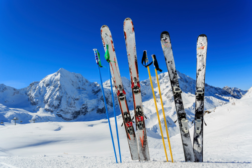 Skis and ski poles standing up in snow