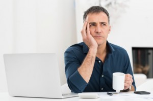 Worried man at his laptop