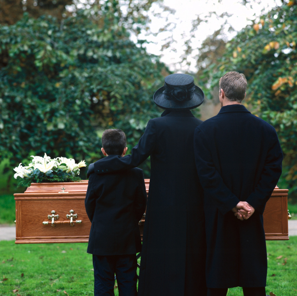 Family standing in cemetery at funeral