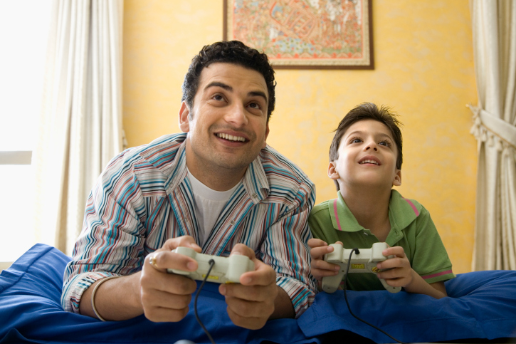 Father playing video games with his son
