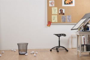 Artist's studio with drafting table and crumpled papers