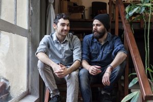 Two young men talking on the stairs