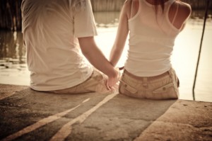 Couple holding hands on stone stairs