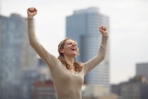 Woman cheering on downtown city street