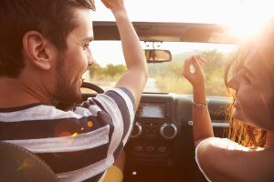 Couple looking at each other while driving